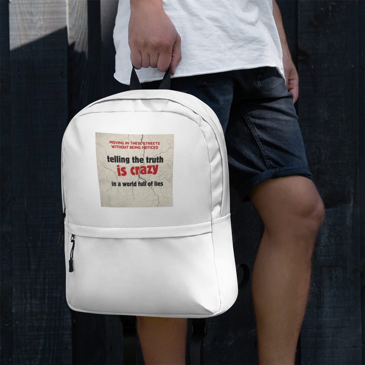 White canvas mini backpack with front logo patch and two zipper pulls