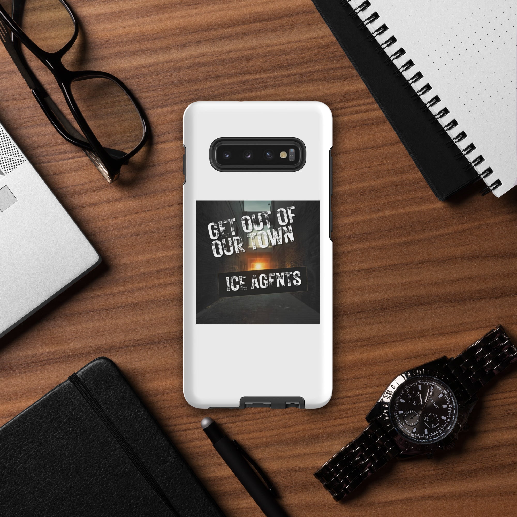 White Samsung phone case showing raised camera frame and “Get Out Of Our Town / Ice Agents” design.