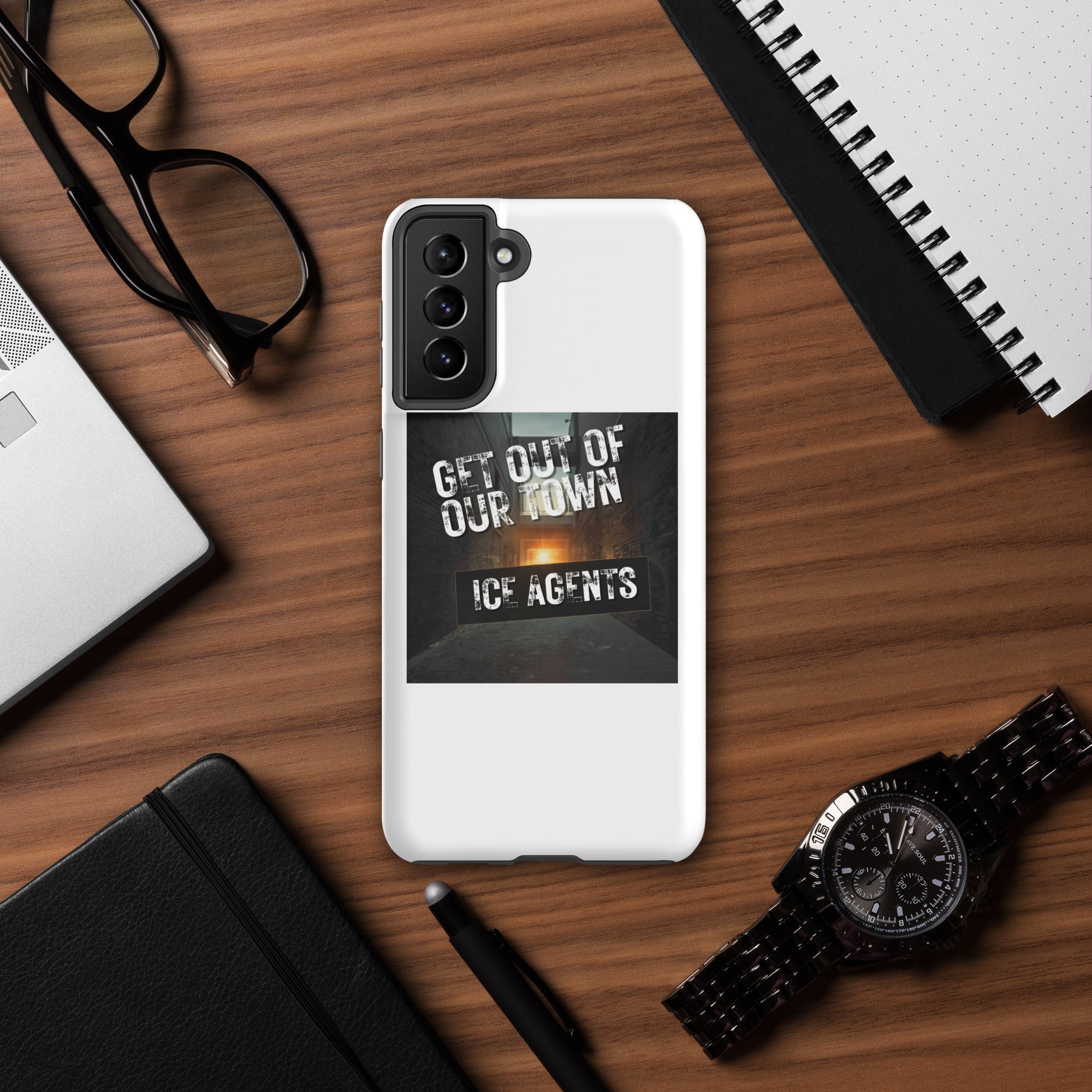White Samsung phone case featuring “Get Out Of Our Town” “Ice Agents” typography design.