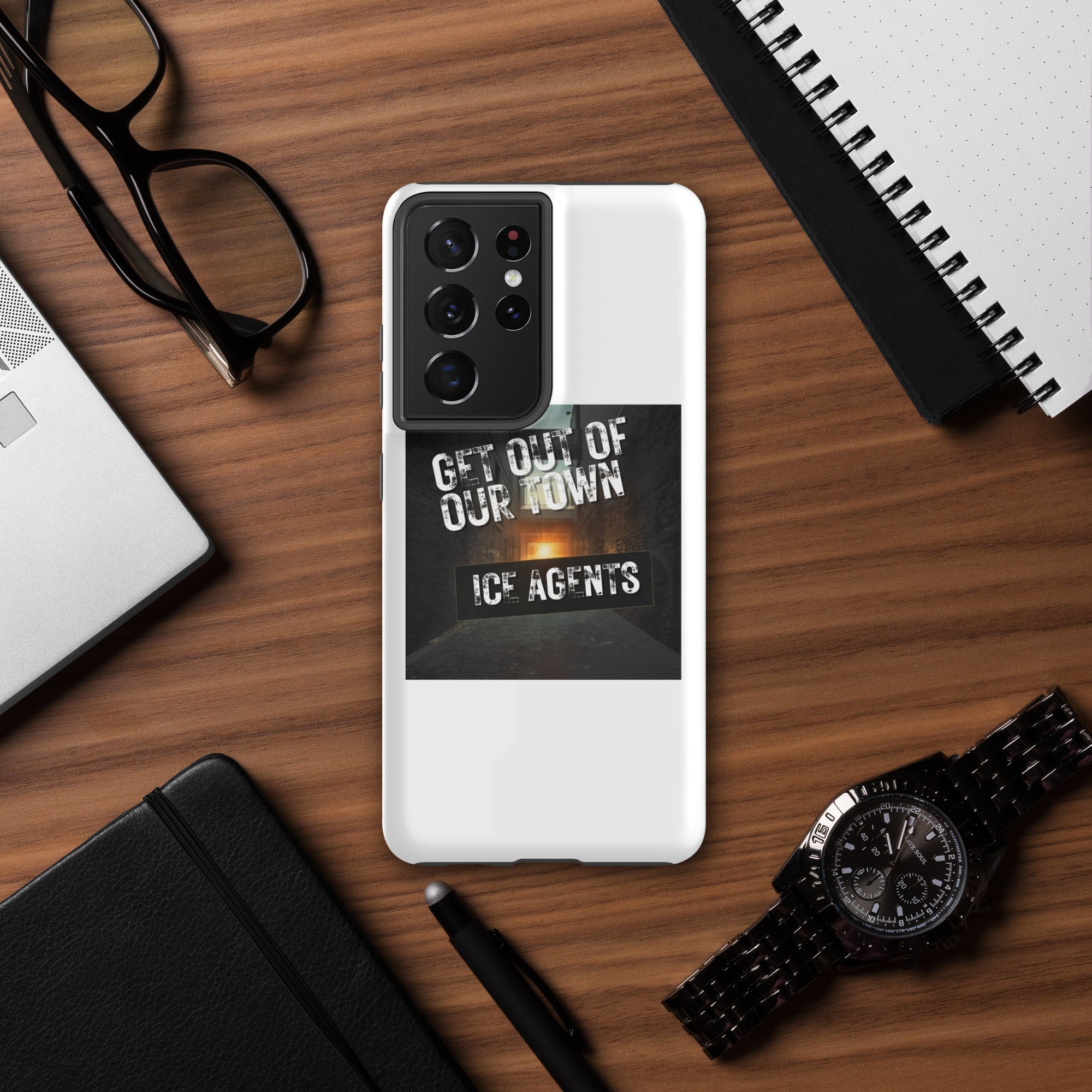White phone case with “Get Out Of Our Town” “Ice Agents” graphic; centered camera cutout.