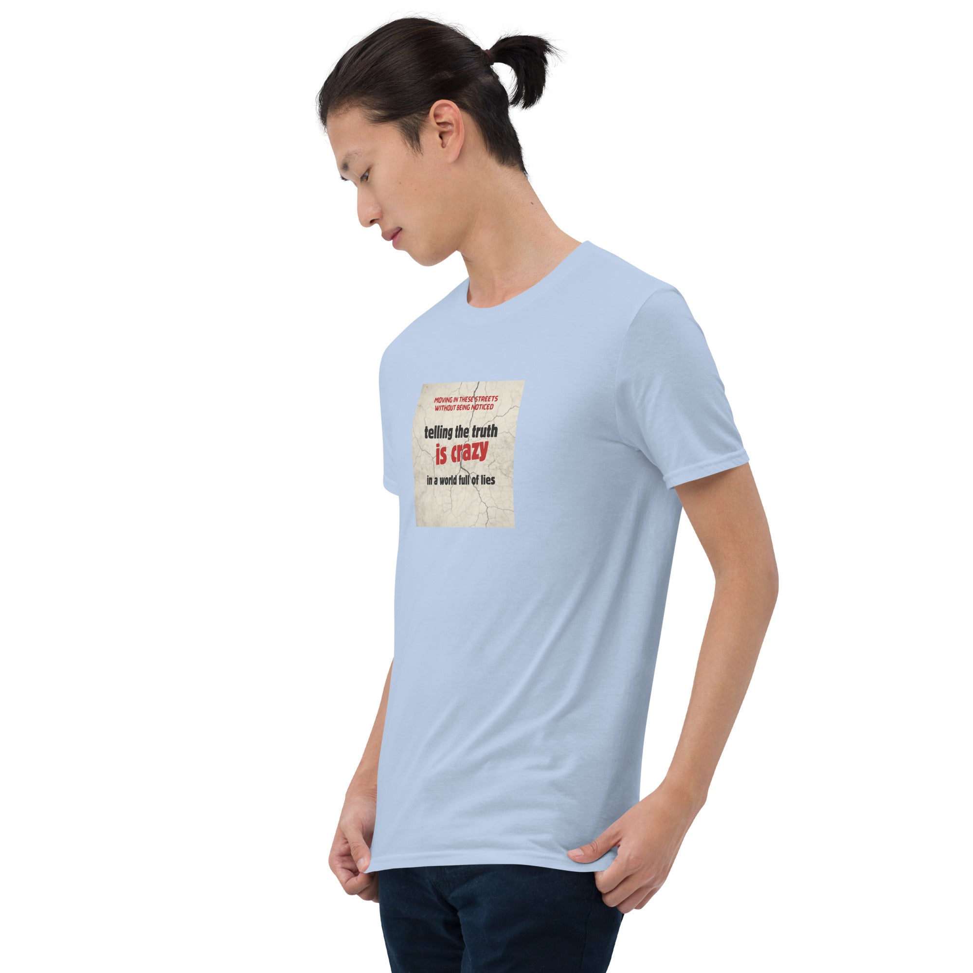 Light blue T-shirt front view, graphic text “telling the truth is crazy”