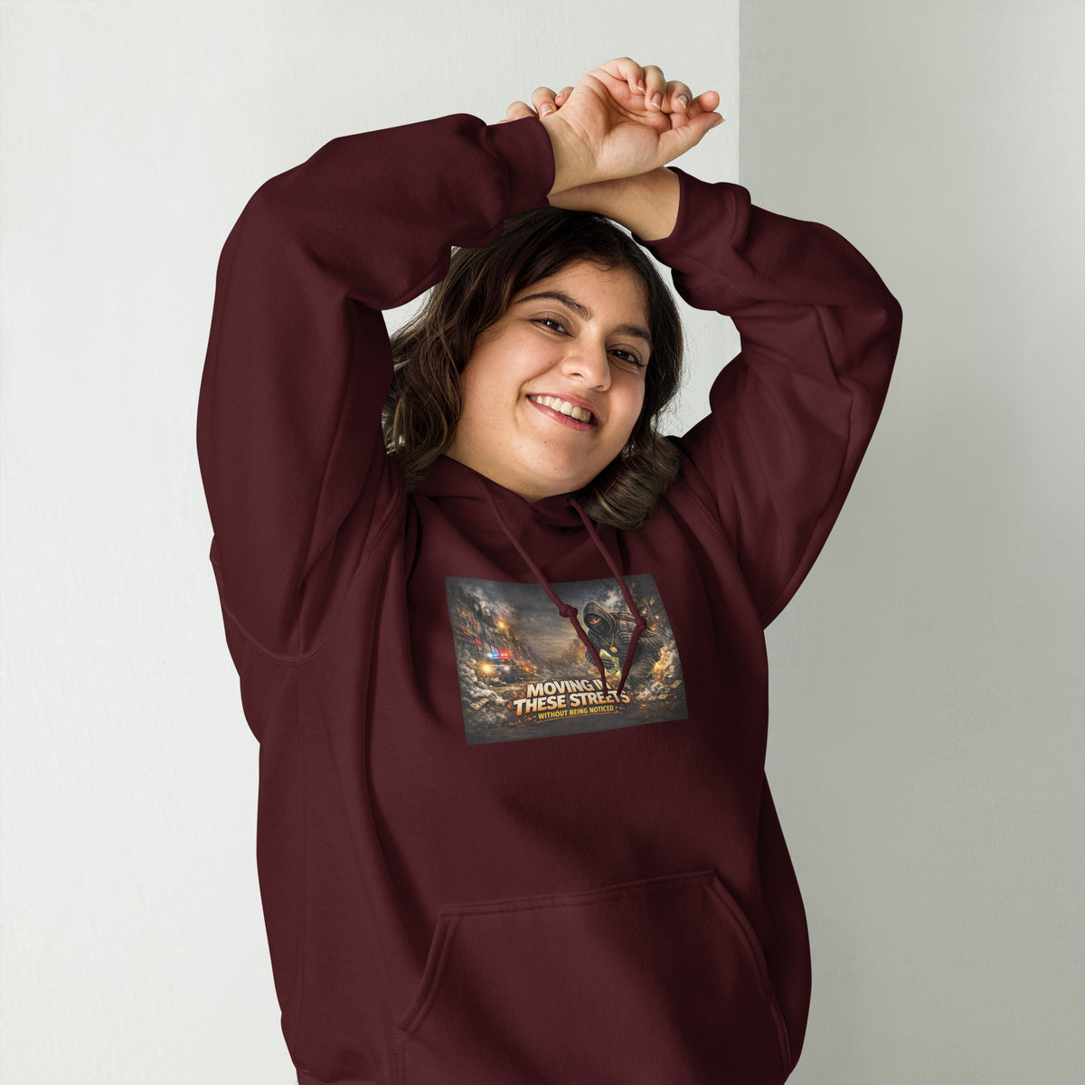 Maroon pullover hoodie with hood, front pocket, and colorful street graphic on chest