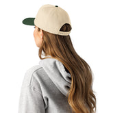 5-panel cap in natural with dark green underside, shown from the side