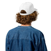 Five-panel cap in white, rear view with curved brim and stitched panels