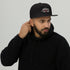 Black snapback hat with embroidered front logo