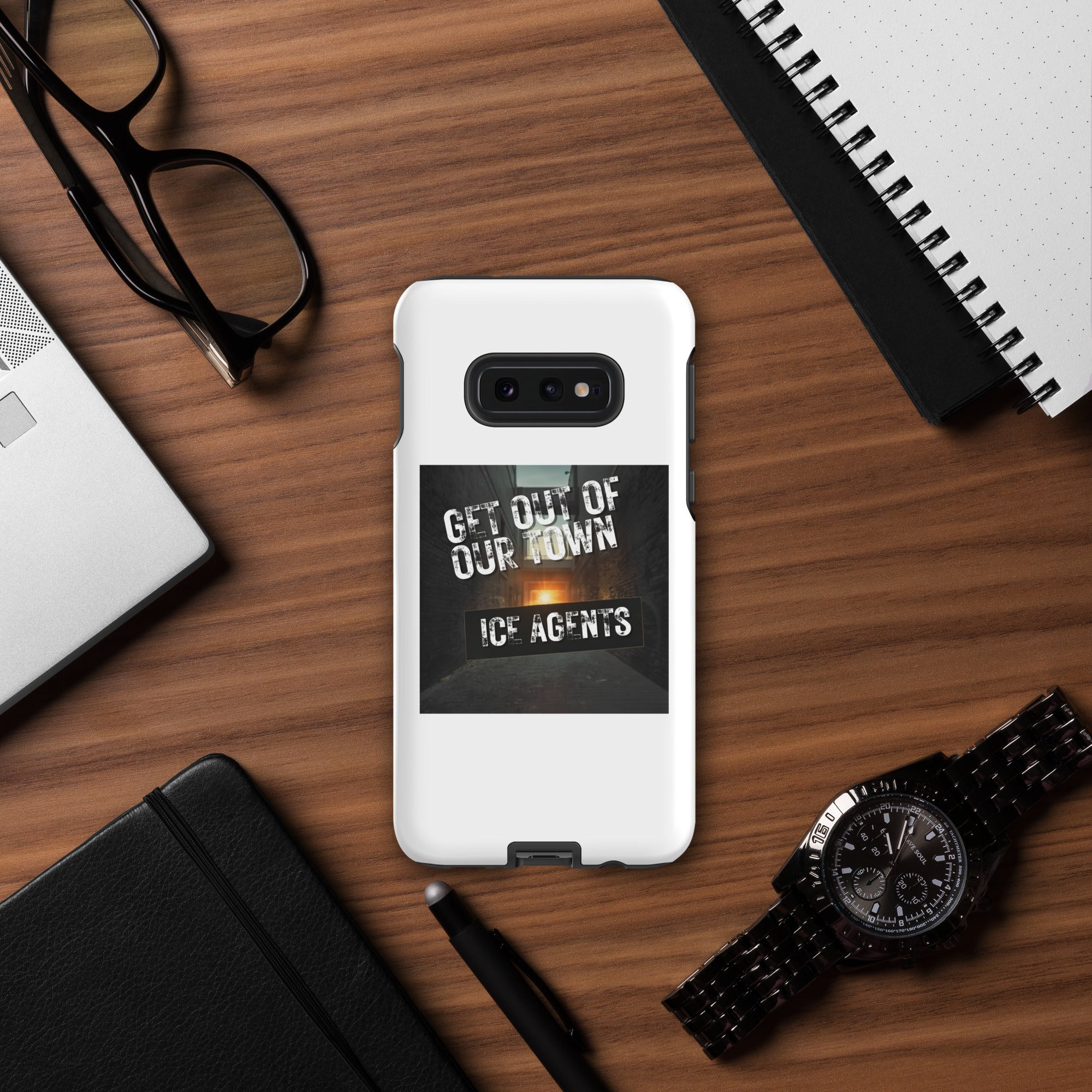 White phone case with black “Get Out Of Our Town” “Ice Agents” text graphic; side kickstand tab.