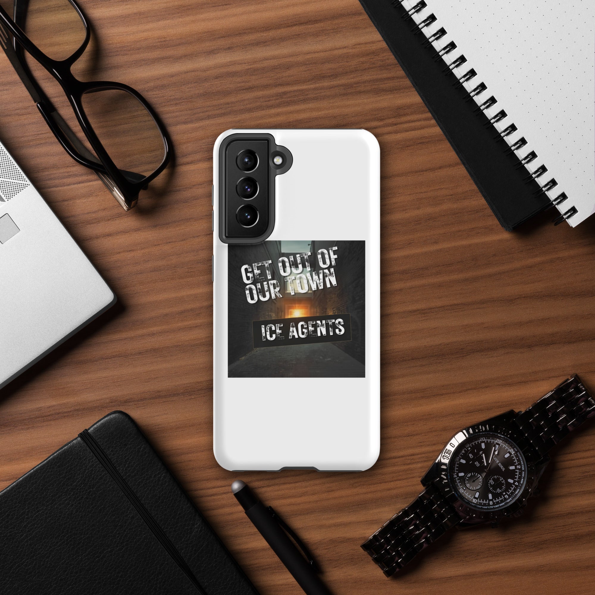 White phone case with “Get Out Of Our Town” “Ice Agents” front graphic and corner protection.