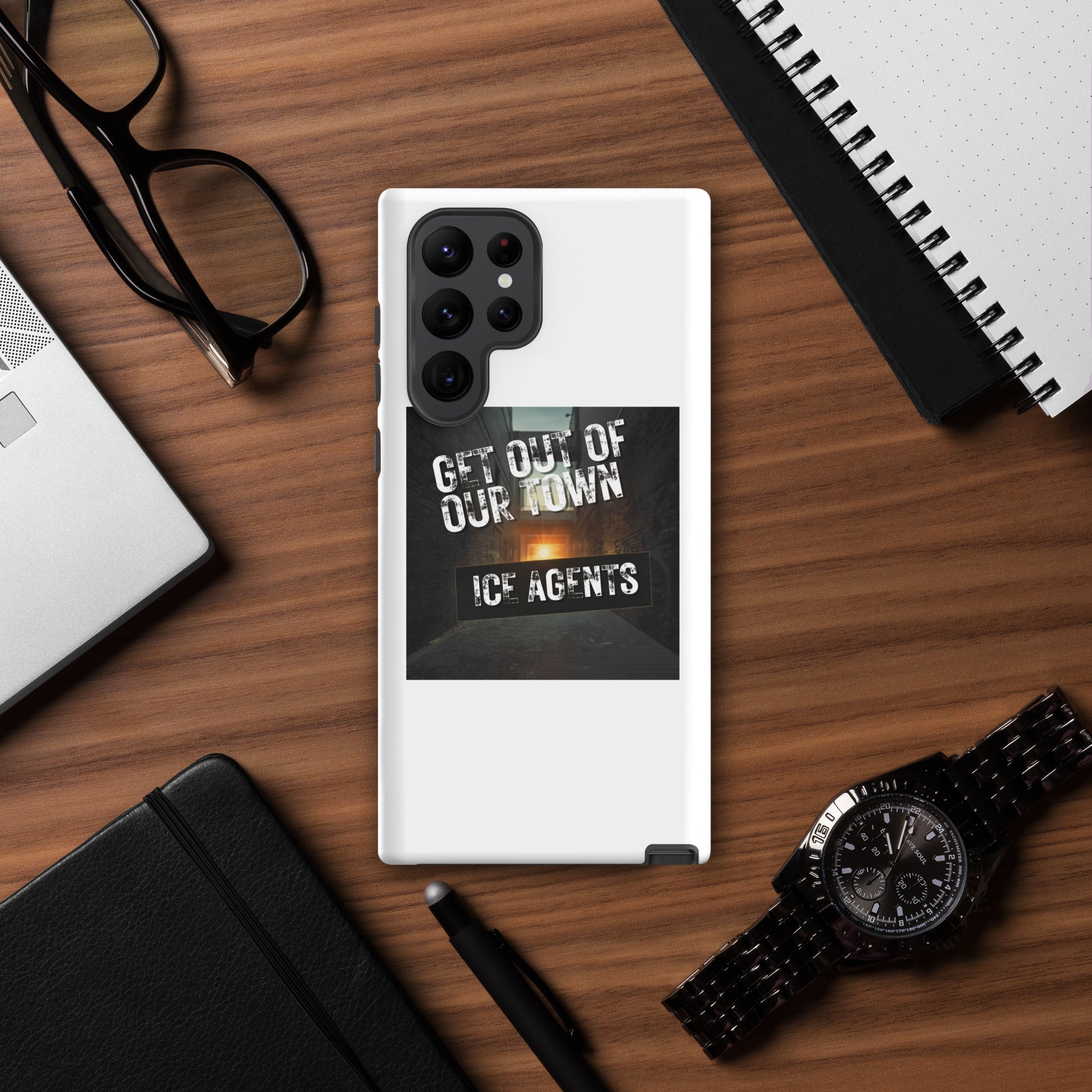White phone case with raised black camera housing and “ICE AGENTS” graphic panel