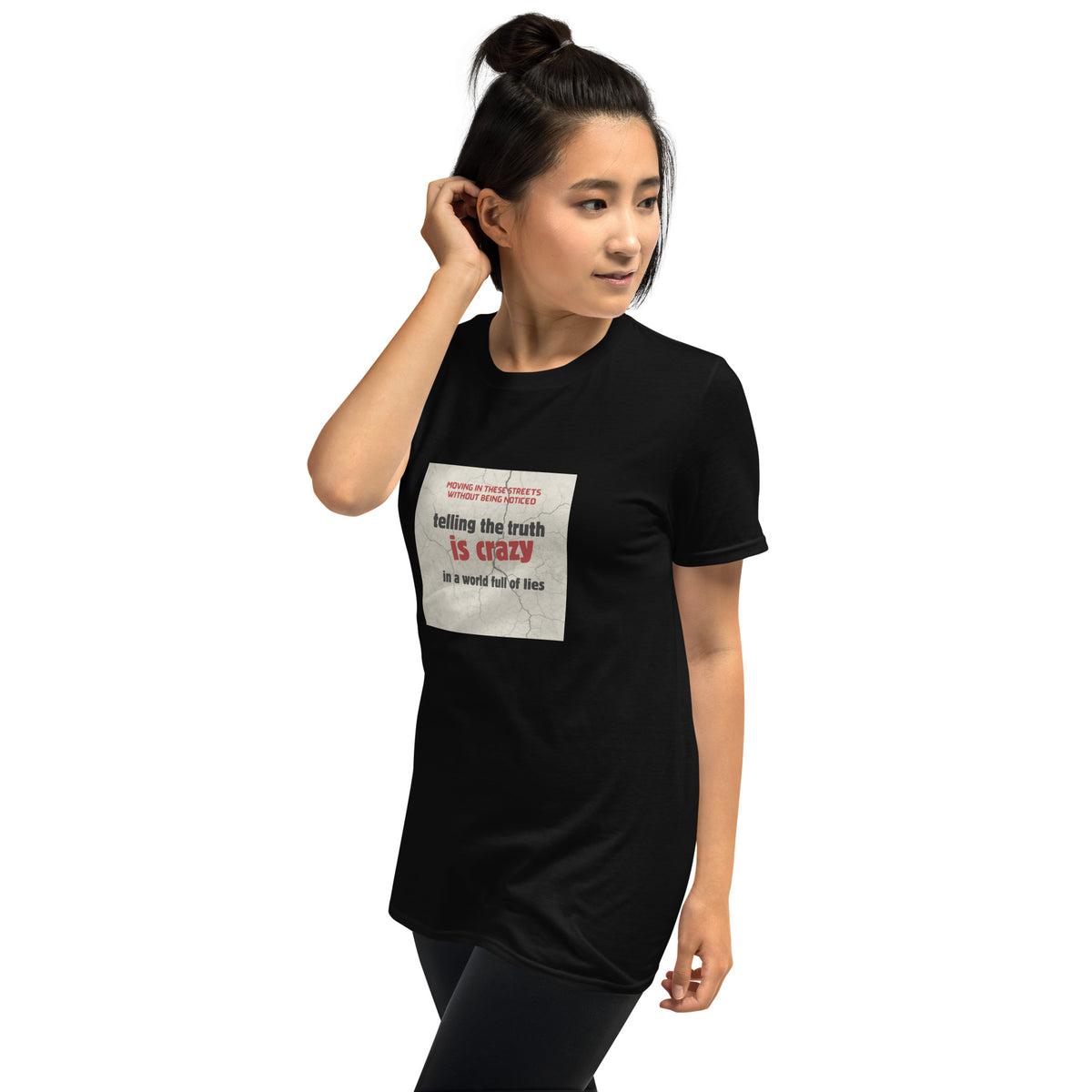 Unisex black graphic t-shirt with front square “telling the truth is crazy” print