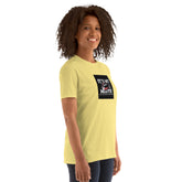 Yellow unisex short-sleeve T-shirt with black square chest logo graphic.