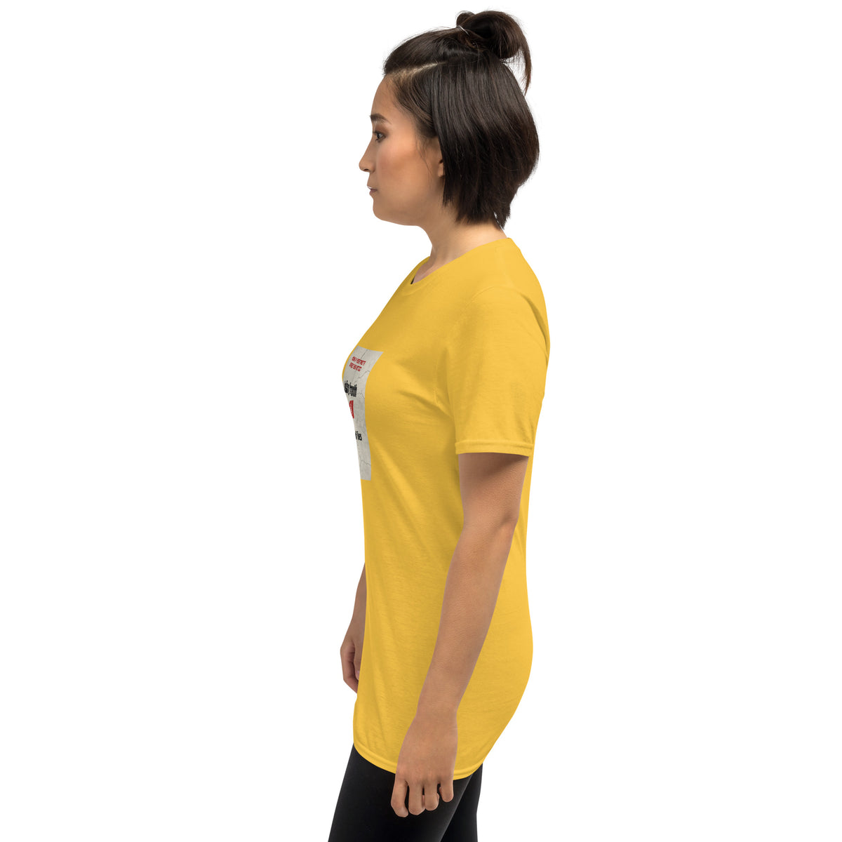 Yellow unisex t-shirt on model, side view with back graphic near shoulder