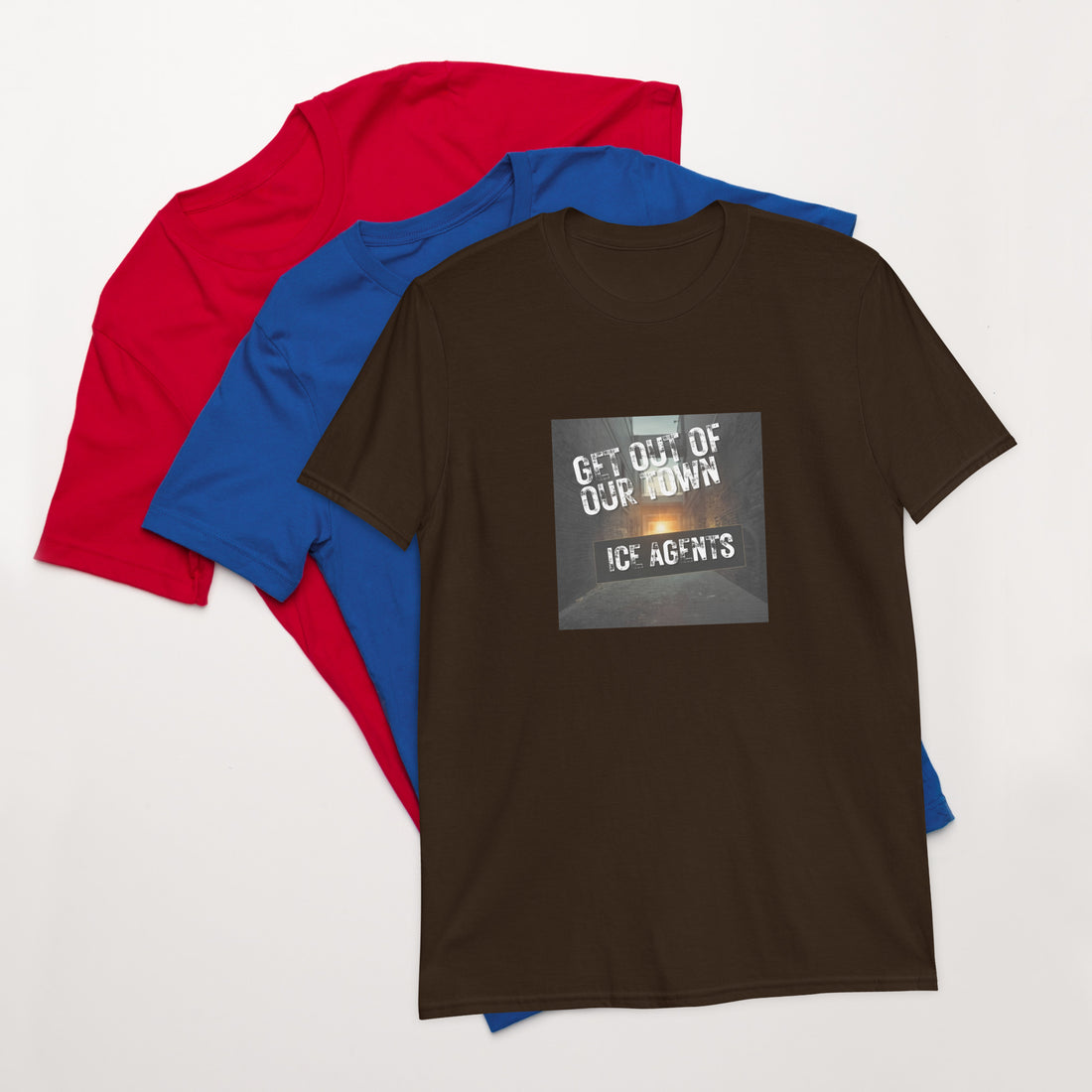 Brown unisex T-shirt with square “Get out of our town” graphic; navy and blue behind