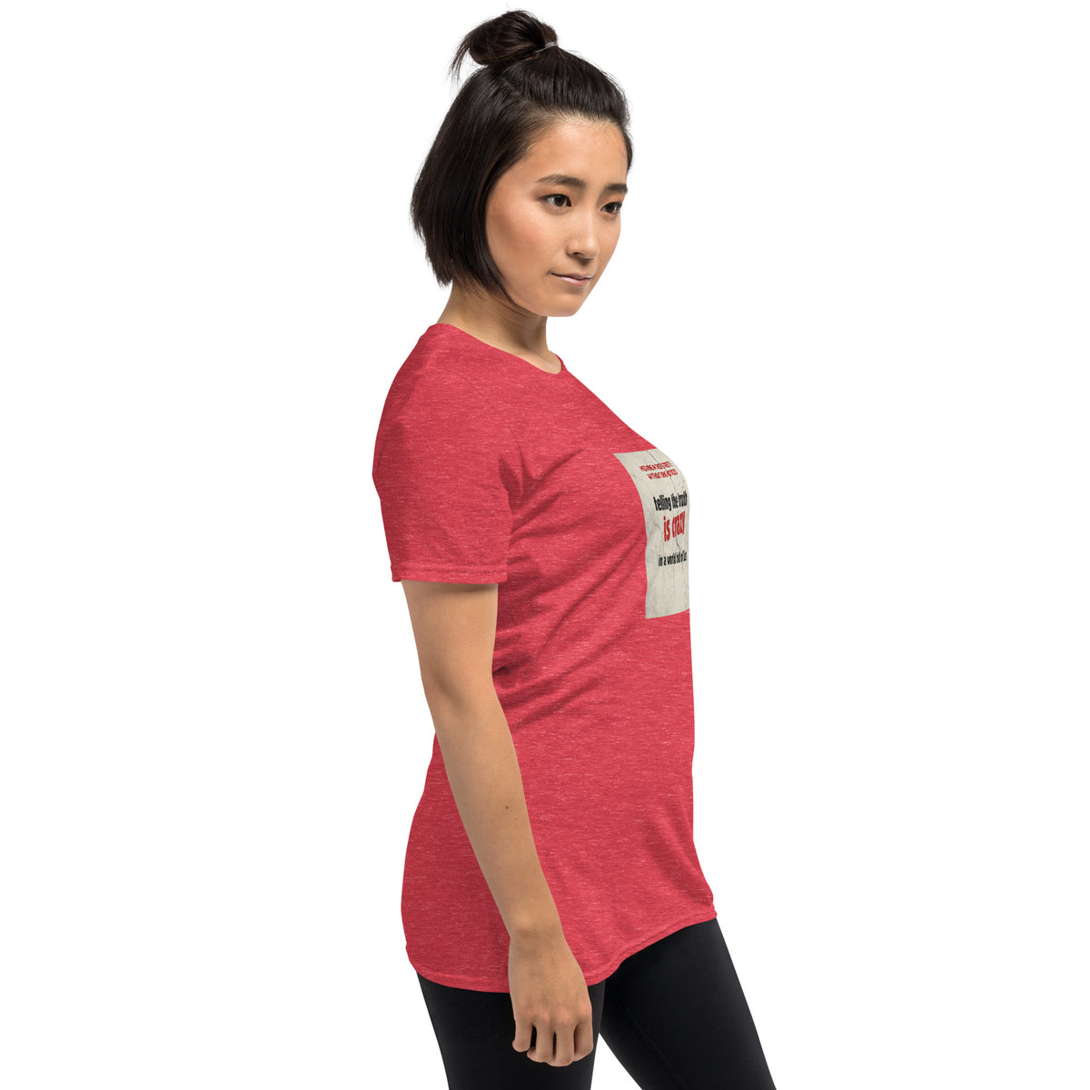 Red unisex T-shirt with chest graphic shown from a side angle.