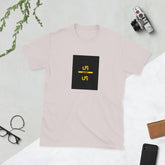 Blush pink graphic tee with black square logo and yellow accents, front view