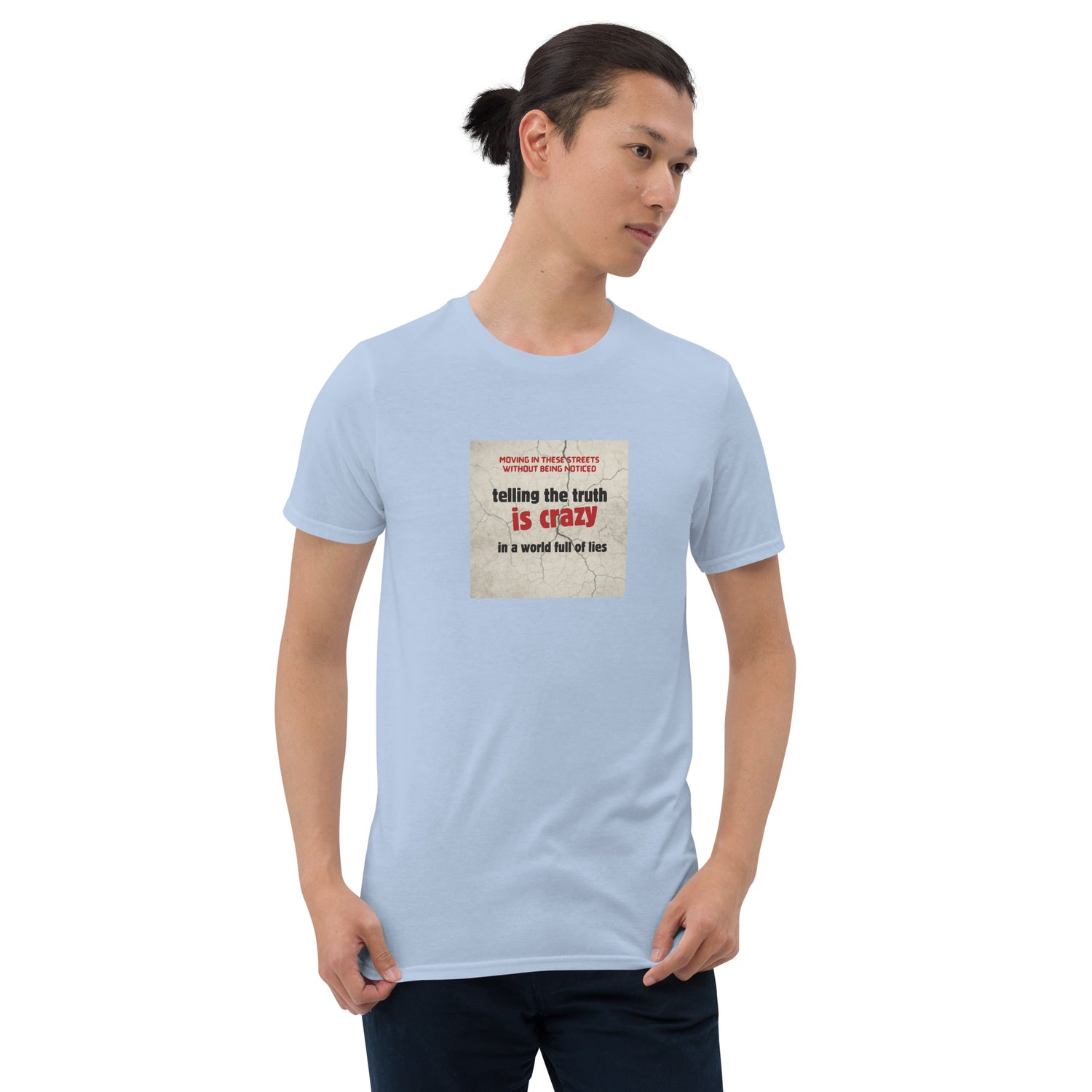 Light blue T-shirt with front graphic: “telling the truth is crazy”