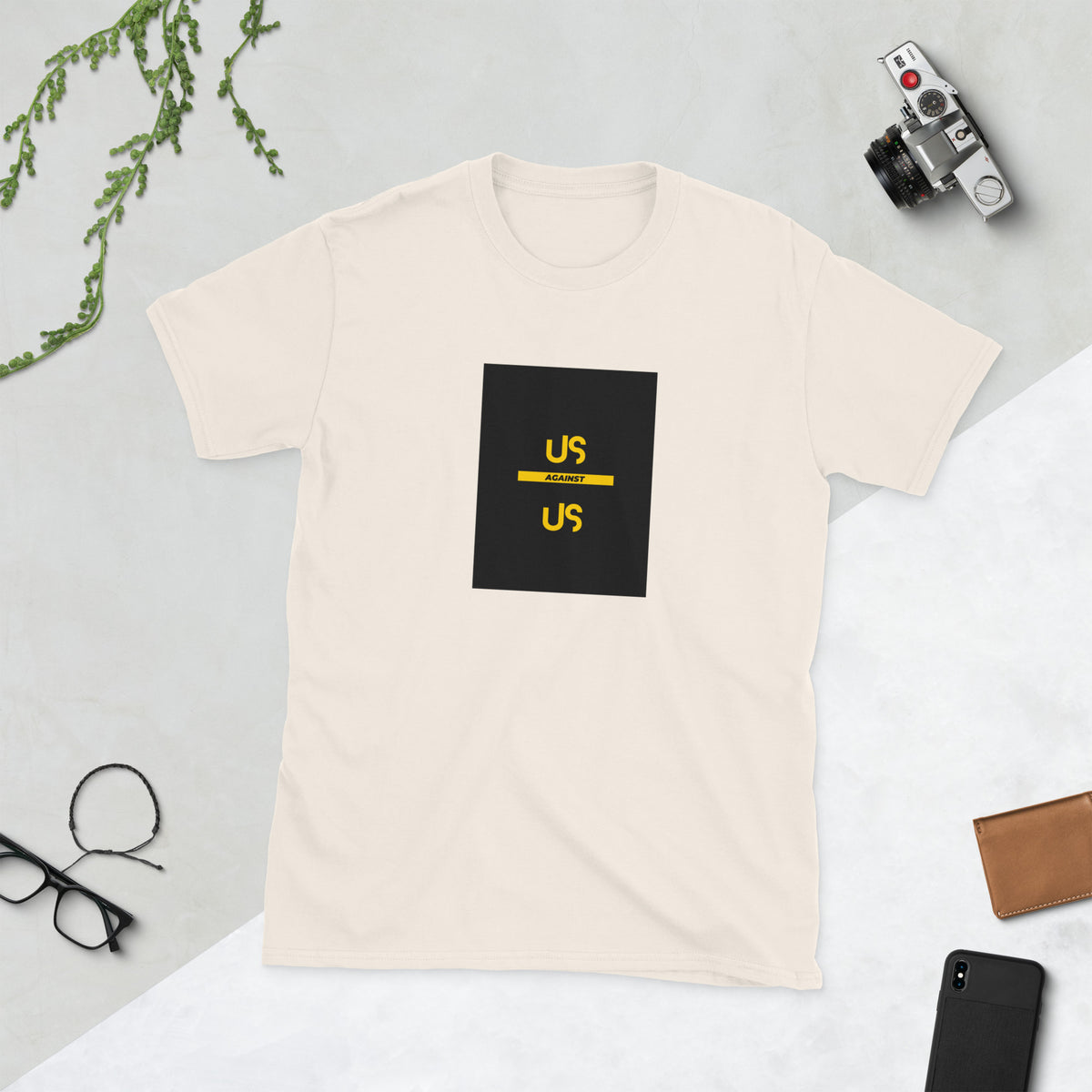 Light cream graphic tee with black square logo and yellow accents, front view
