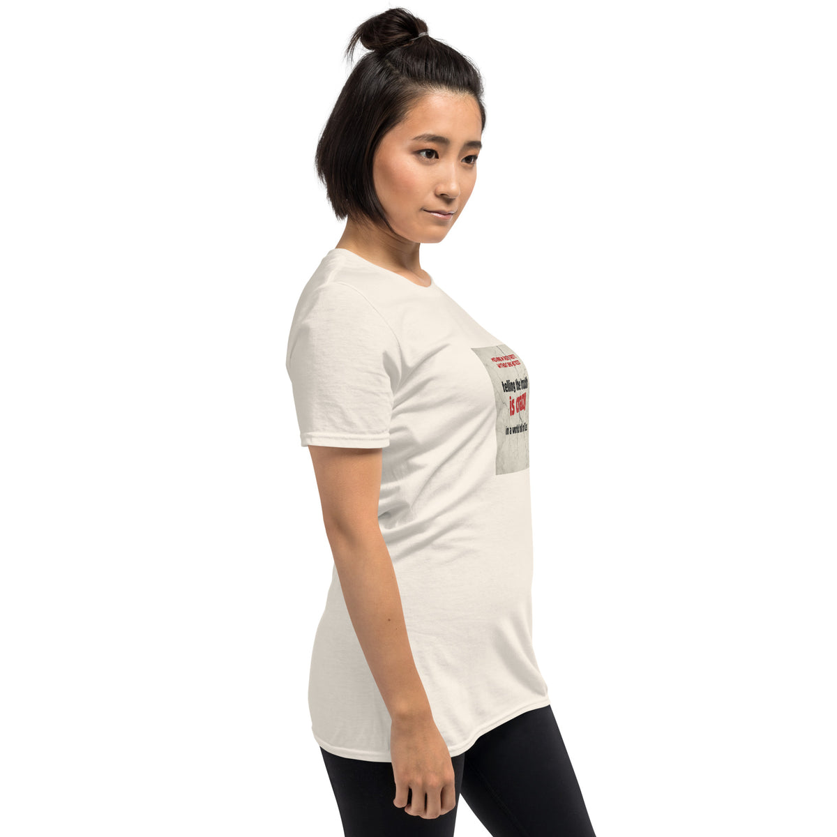 White unisex T-shirt with chest graphic shown from a side angle.