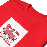 Red graphic tee with pink “You & Me” couple on white diamond patch