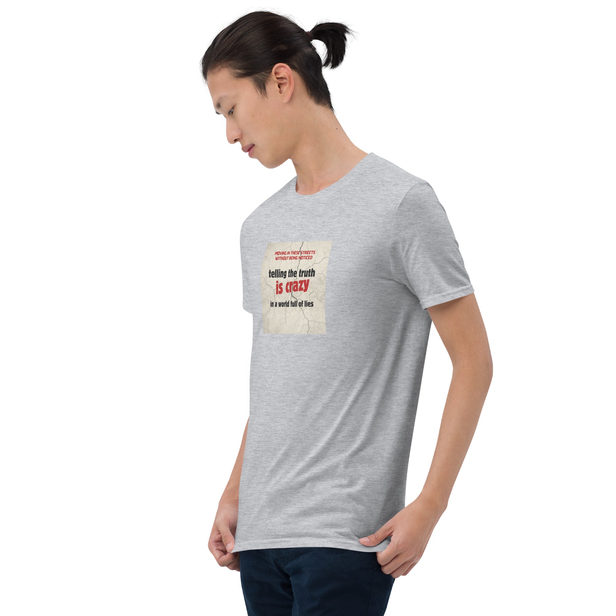 Heather gray T-shirt angled front view with graphic text “telling the truth is crazy”
