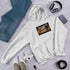 Unisex white hoodie with kangaroo pocket, chest graphic, and hood up