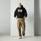Black unisex pullover hoodie with front pouch and chest graphic print, hood up
