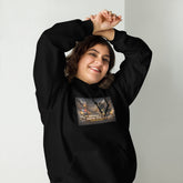 Black pullover hoodie with hood, front pocket, and colorful street graphic on chest