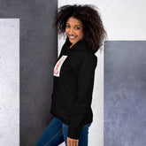 Black unisex hoodie with hood and chest patch graphic, side view