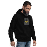 Black unisex hoodie with hood, front pouch pocket, and small chest graphic patch.