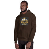 Unisex pullover hoodie in dark brown with hood and front graphic patch; side view.