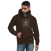 Dark chocolate unisex hoodie with hood, front pouch pocket, and small chest graphic patch.
