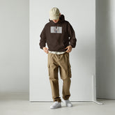 Brown unisex pullover hoodie with front pouch and chest graphic print, hood up