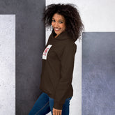 Dark brown unisex hoodie with hood, front pocket, and small left-chest graphic patch