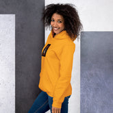 Unisex yellow hoodie with small front graphic patch, pullover hood, and cuffed sleeves.