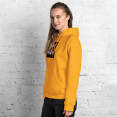 Unisex mustard yellow hoodie with side view, hood, and chest logo patch
