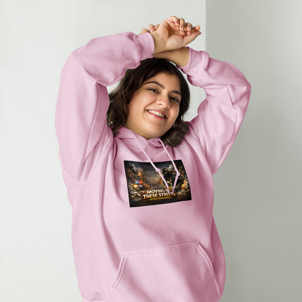 Light pink pullover hoodie with hood, front pocket, and colorful street graphic on chest