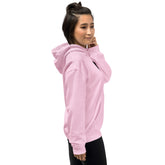 Light Pink unisex hoodie, side view with hood up and BELIEVE chest graphic
