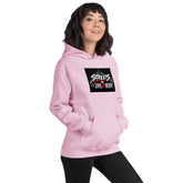 Unisex pink hoodie with hood and front pocket; chest graphic and drawstring visible.