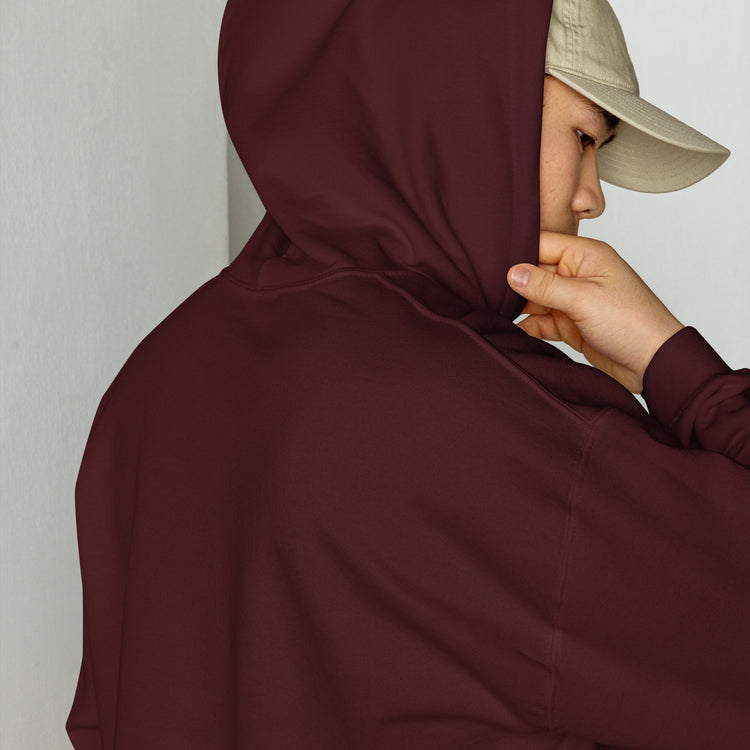 Maroon unisex hoodie close-up with drawstring hood and front pouch, hand holding collar