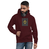 Maroon unisex hoodie with hood, front pouch pocket, and small chest graphic patch.