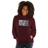 Maroon pullover hoodie with hood, front pouch pocket, and chest photo-style graphic.