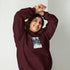 Maroon unisex hoodie with chest graphic, hood with drawstrings, and front pouch pocket