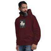Unisex pullover hoodie in maroon with hood, front pocket, and chest graphic print.