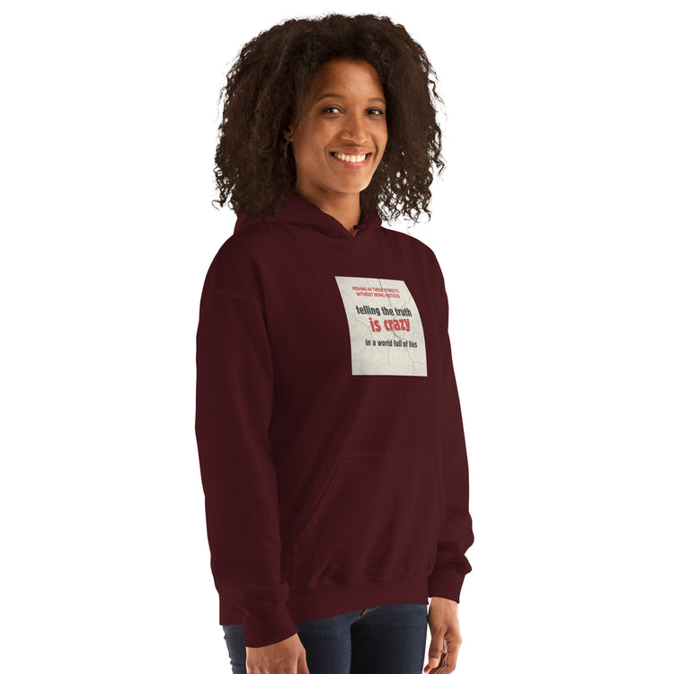 Maroon unisex hoodie with hood and chest logo patch, front three-quarter view
