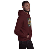 Maroon unisex pullover hoodie with hood and front graphic patch; side profile view.