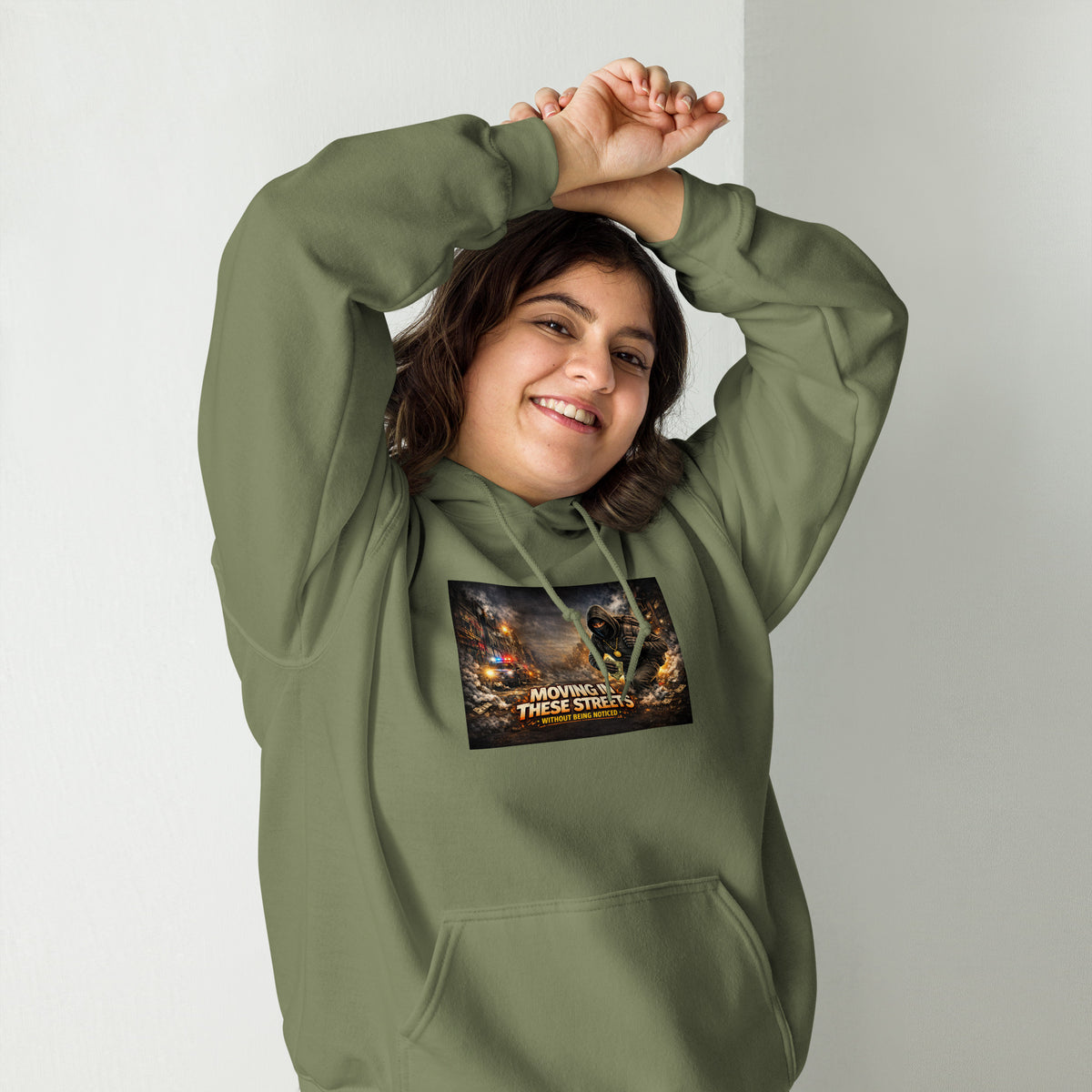 Olive green pullover hoodie with hood, front pocket, and colorful street graphic on chest