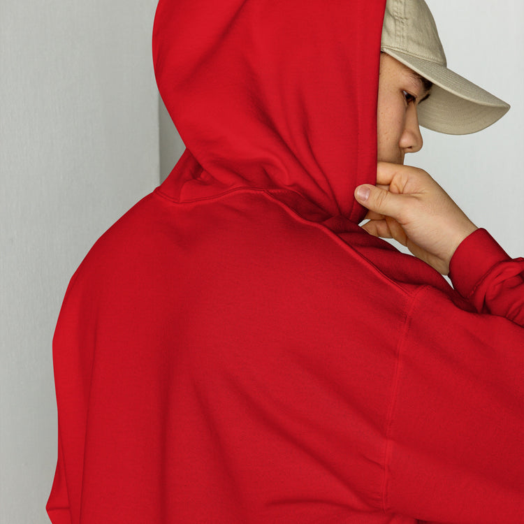 Red unisex hoodie close-up with drawstring hood and front pouch, hand holding collar