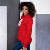 Red unisex hoodie with hood and front graphic patch, side view