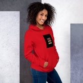 Unisex red pullover hoodie with hood, kangaroo pocket, and front graphic patch (front view)