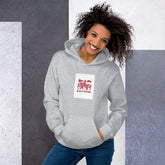 Unisex hoodie in light heather gray with front graphic patch and kangaroo pocket.
