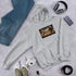 Unisex ash gray hoodie with chest graphic and front kangaroo pocket